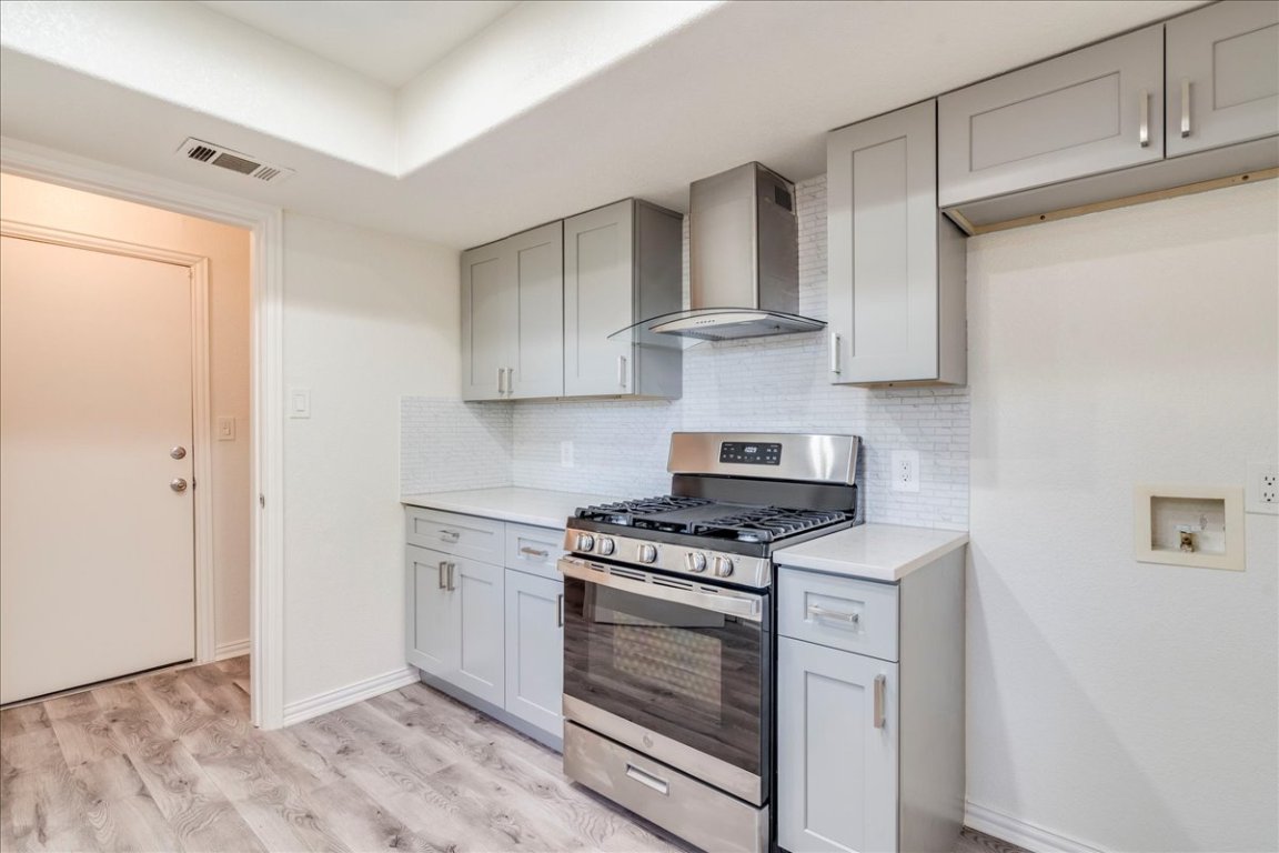706 Windsor Road Round Rock, TX 78664 - Photo 13 of 29 a kitchen with white cabinets and appliances