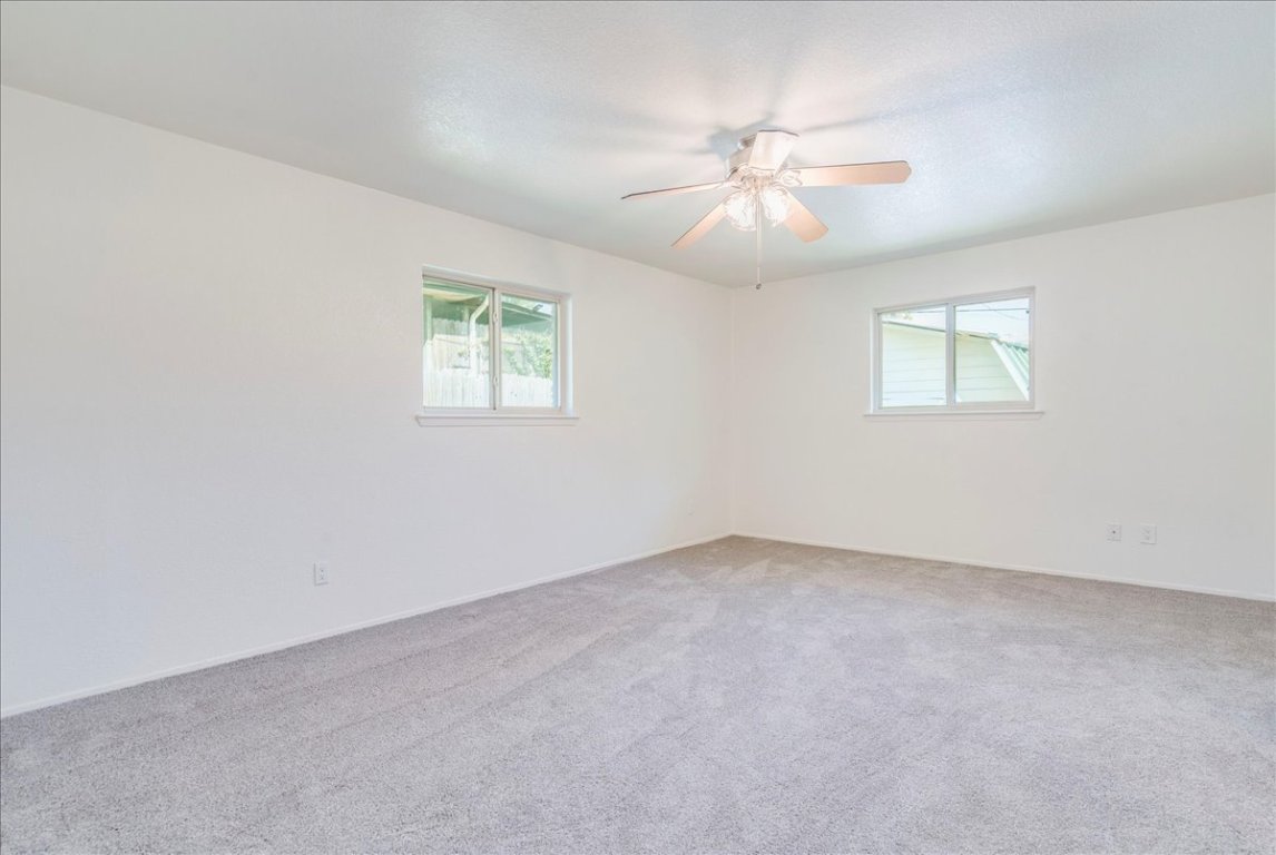 706 Windsor Road Round Rock, TX 78664 - Photo 15 of 29 an empty room with windows and fan