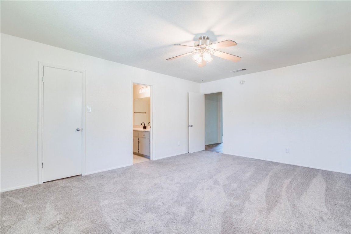 706 Windsor Road Round Rock, TX 78664 - Photo 16 of 29 an empty room with closet and fan