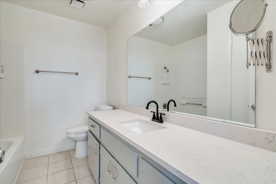 706 Windsor Road Round Rock, TX 78664 - Photo 17 of 29 a bathroom with a sink toilet and a mirror