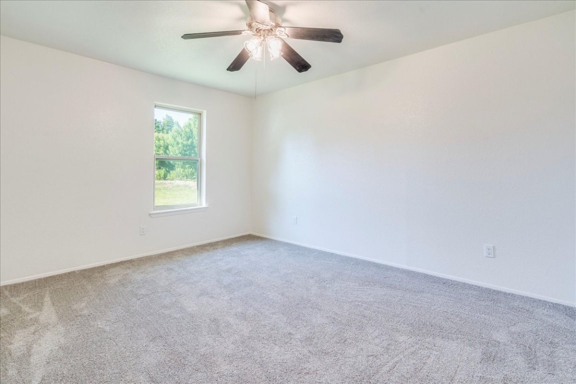 706 Windsor Road Round Rock, TX 78664 - Photo 19 of 29 an empty room with windows and fan