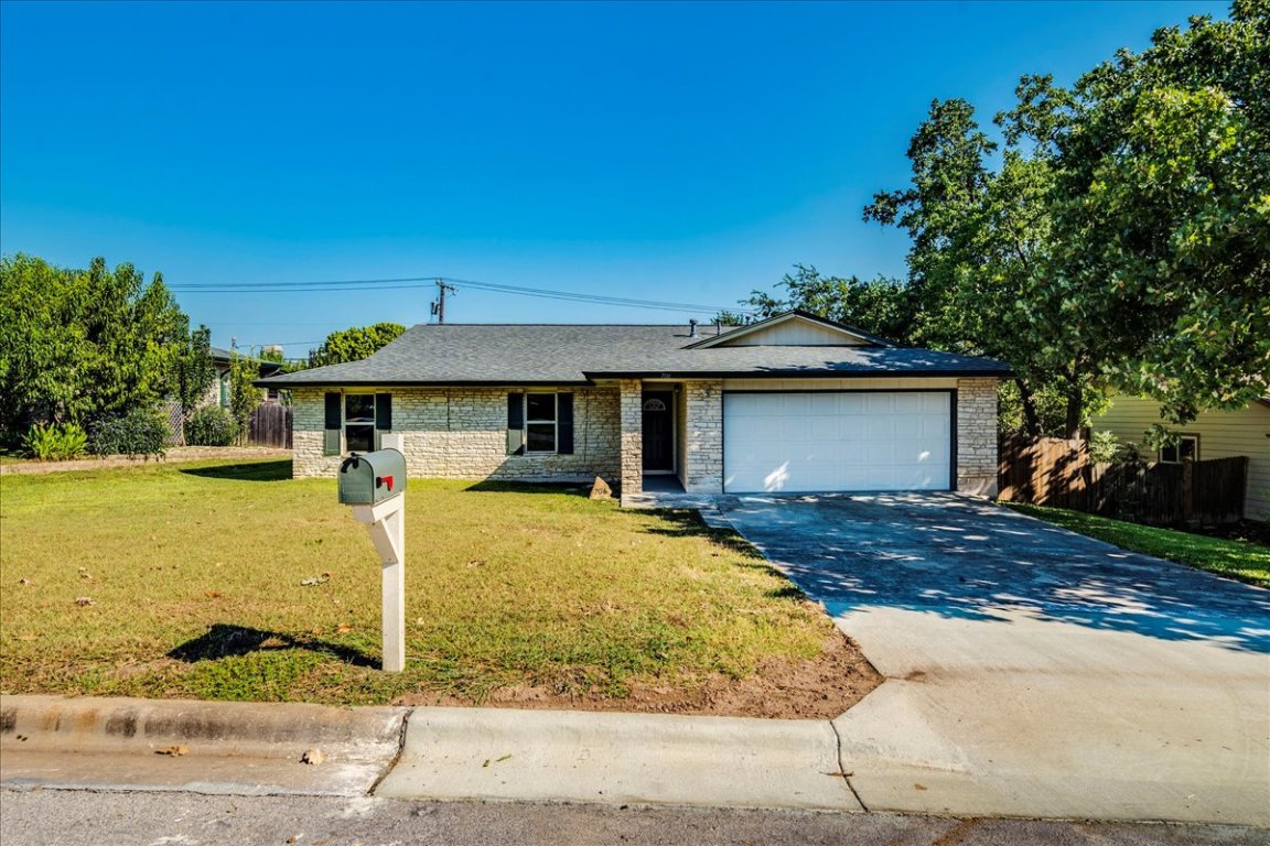 706 Windsor Road Round Rock, TX 78664 - Photo 2 of 29 a front view of a house with a yard