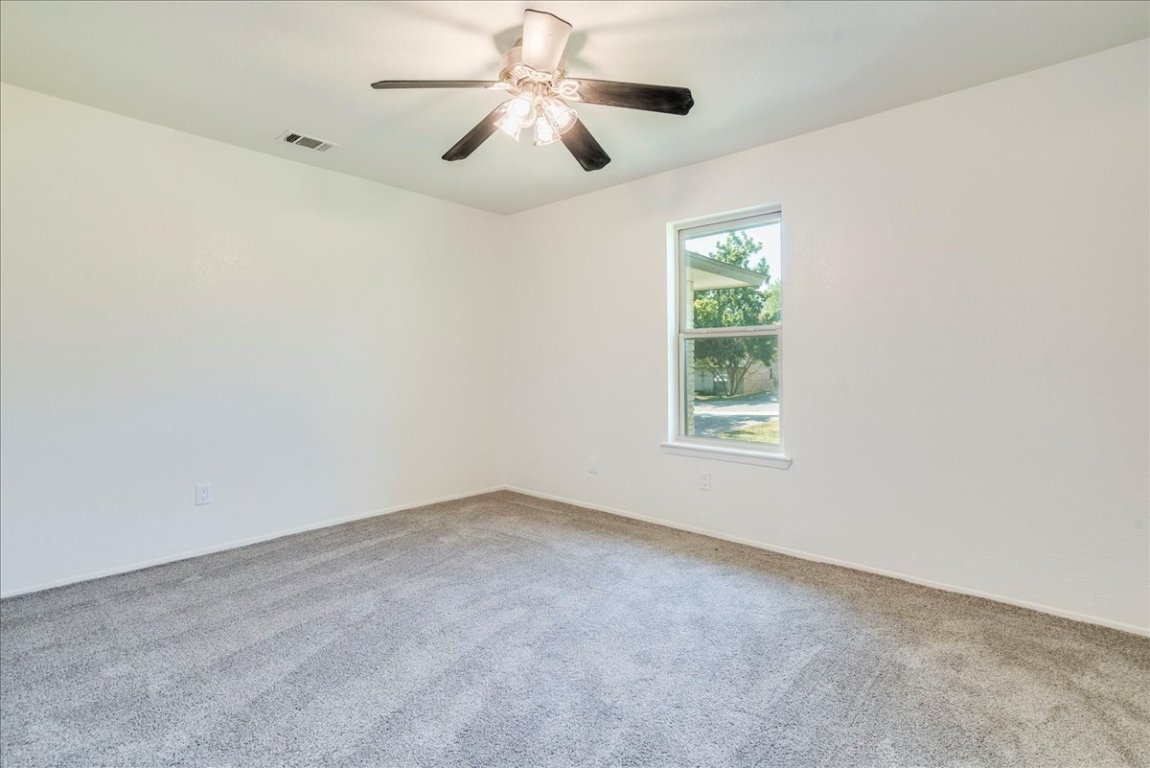 706 Windsor Road Round Rock, TX 78664 - Photo 21 of 29 an empty room with a window and a fan
