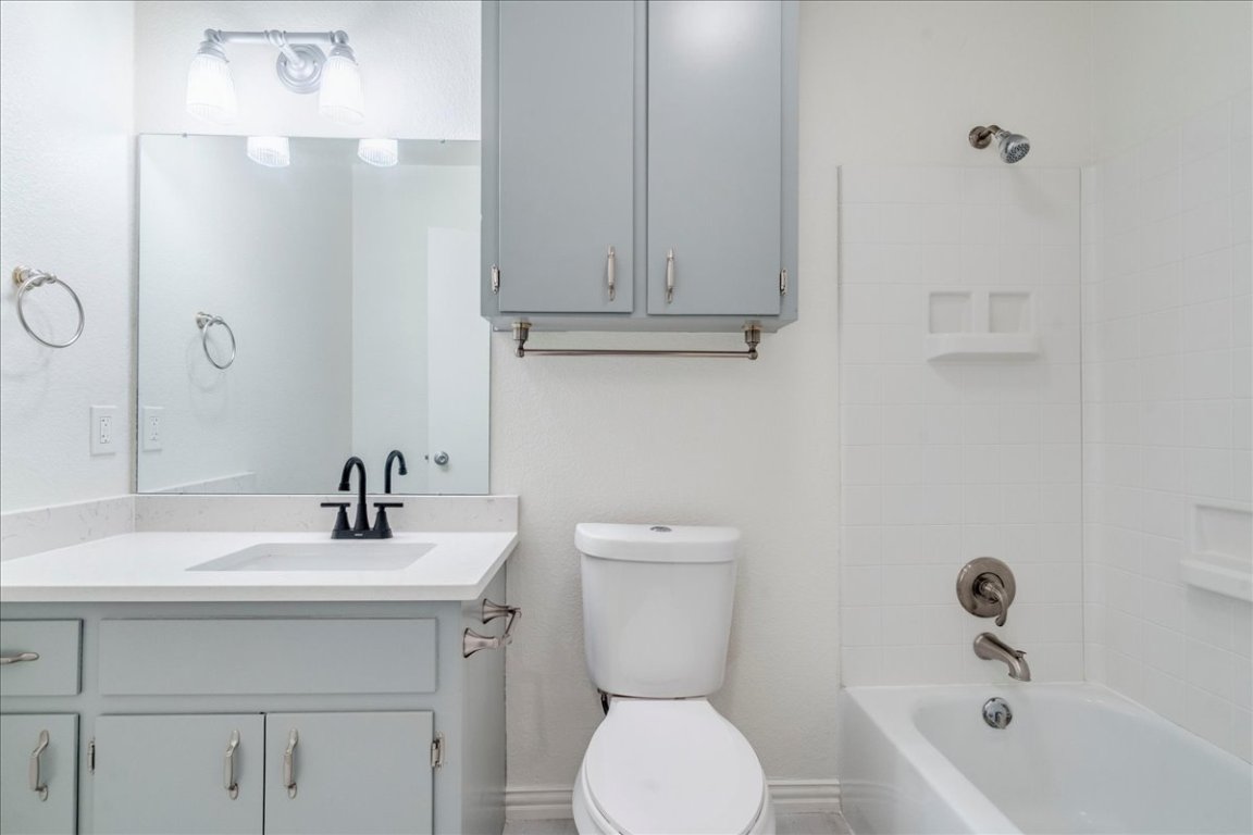 706 Windsor Road Round Rock, TX 78664 - Photo 23 of 29 a bathroom with a sink a toilet and bathtub