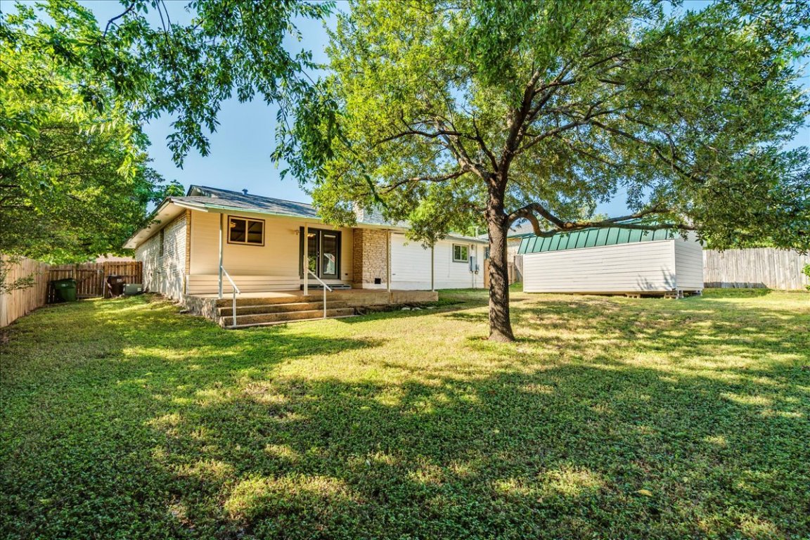 706 Windsor Road Round Rock, TX 78664 - Photo 27 of 29 a backyard of a house with table and chairs