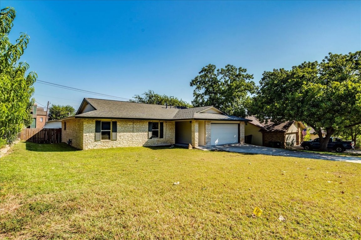 706 Windsor Road Round Rock, TX 78664 - Photo 4 of 29 a front view of a house with yard and trees