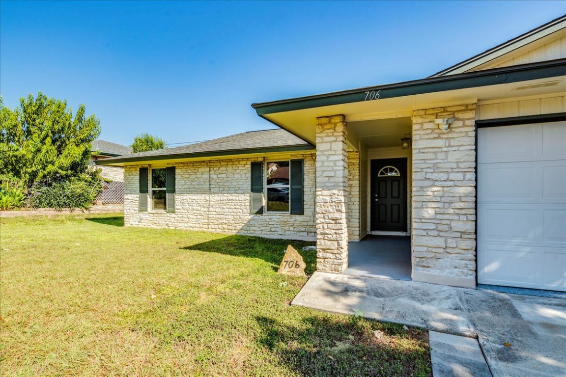 706 Windsor Road Round Rock, TX 78664 - Photo 6 of 29 a view of a house with table and chairs in patio