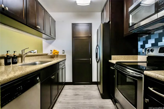 a kitchen with stainless steel appliances granite countertop a refrigerator a sink and dishwasher