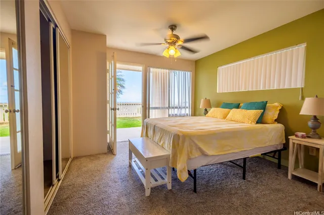 a bed sitting in a spacious bedroom next to a window