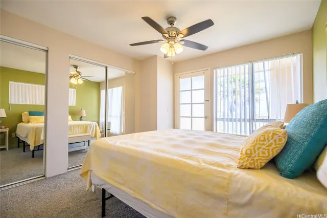 a bedroom with a bed and a large window