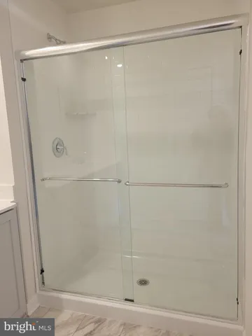 a bathroom with a glass shower door