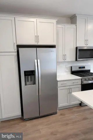 a kitchen with stainless steel appliances a refrigerator sink and microwave