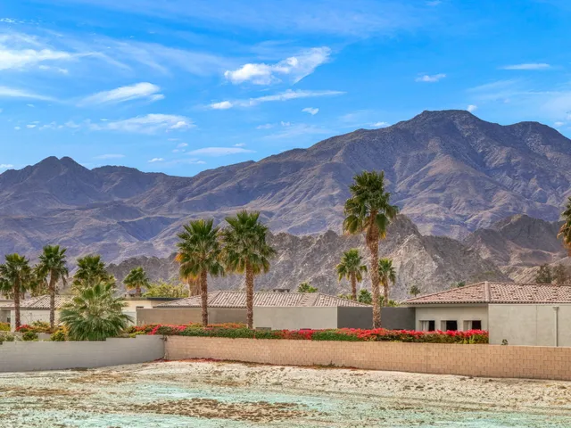 a view of living room with furniture and large windows