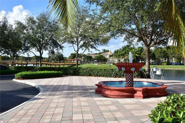 a view of a fountain with potted plants