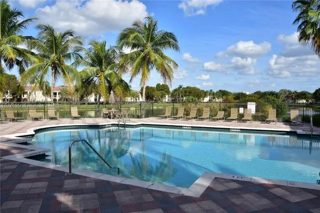 a view of swimming pool with outdoor seating and plants