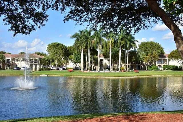 a view of swimming pool with outdoor seating and lake view