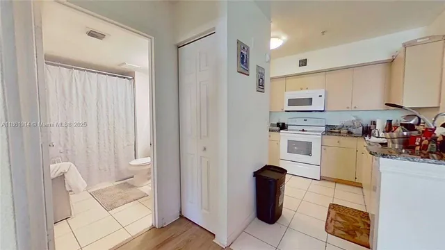 a kitchen with stainless steel appliances granite countertop a refrigerator sink and stove