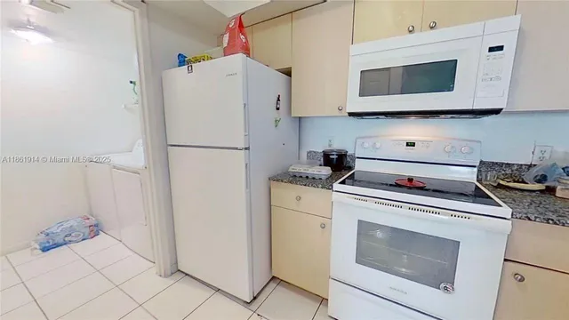 a kitchen with stainless steel appliances granite countertop white cabinets and a stove