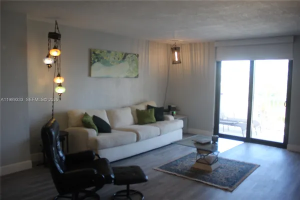 a living room with furniture a lamp and a window