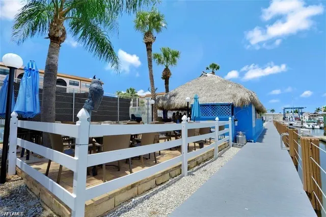 a view of a lake with a yard and large trees