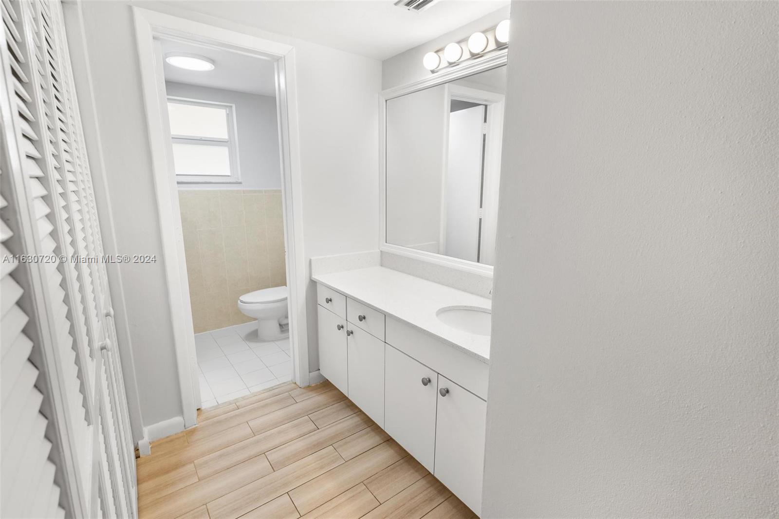 7430 Miami Lakes Drive, Unit E302 Miami Lakes, FL 33014 - Photo 15 of 29 a bathroom with a sink a toilet and shower