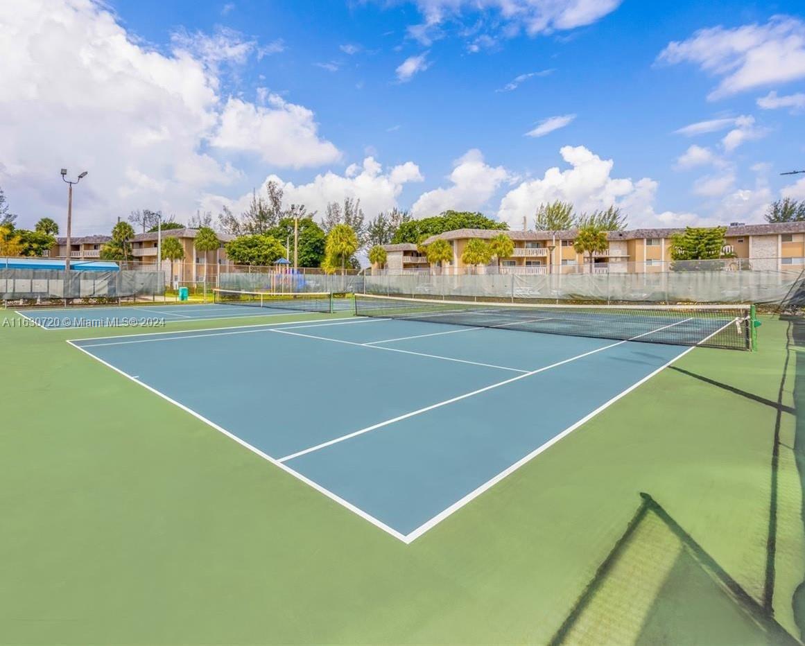 7430 Miami Lakes Drive, Unit E302 Miami Lakes, FL 33014 - Photo 23 of 29 a view of an outdoor space and tennis court