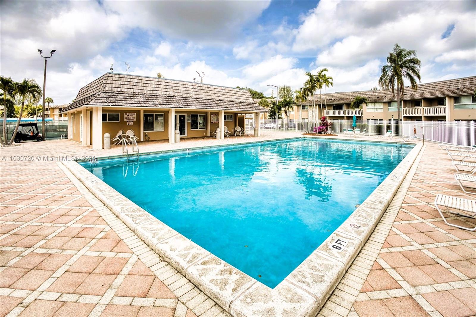7430 Miami Lakes Drive, Unit E302 Miami Lakes, FL 33014 - Photo 24 of 29 a view of a house with swimming pool and sitting area