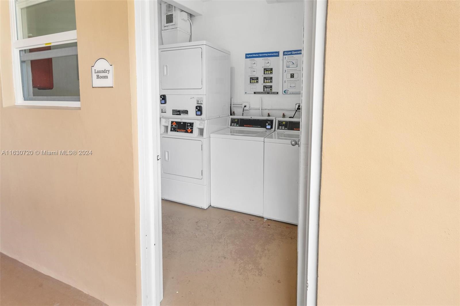 7430 Miami Lakes Drive, Unit E302 Miami Lakes, FL 33014 - Photo 27 of 29 a kitchen with cabinets and a refrigerator