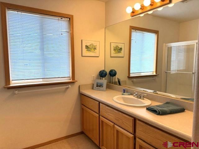 30022 Rd L Mancos, CO 81328 - Photo 13 of 16 a bathroom with a sink and a mirror