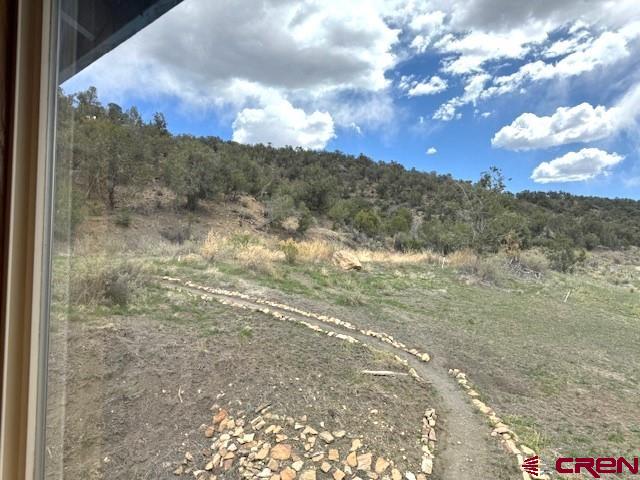 30022 Rd L Mancos, CO 81328 - Photo 15 of 16 a view of a dry yard with mountains in the background