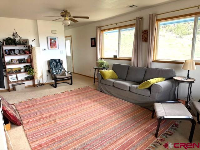 30022 Rd L Mancos, CO 81328 - Photo 3 of 16 a living room with furniture a wooden floor and a large window