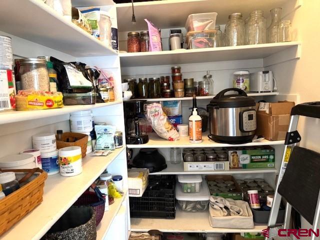 30022 Rd L Mancos, CO 81328 - Photo 6 of 16 a kitchen with lots of clutter and cabinets