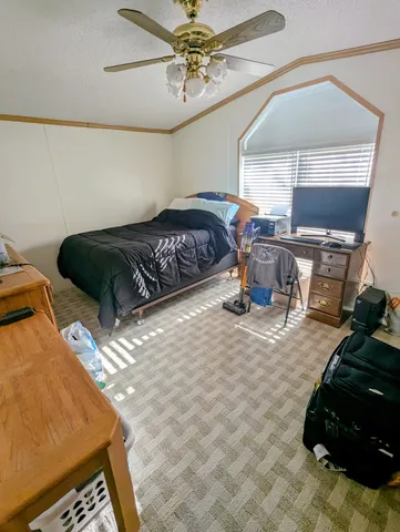 a bedroom with a bed and window