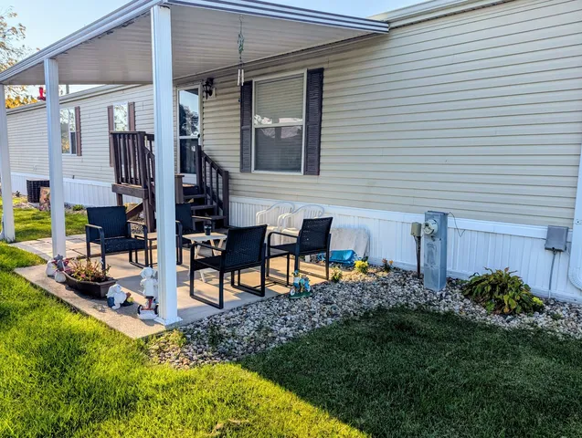 a view of a house with backyard and sitting area