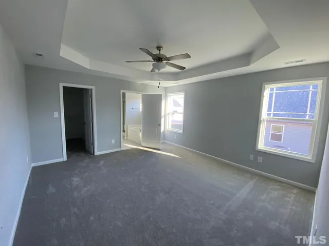 a view of a livingroom with a ceiling fan and window