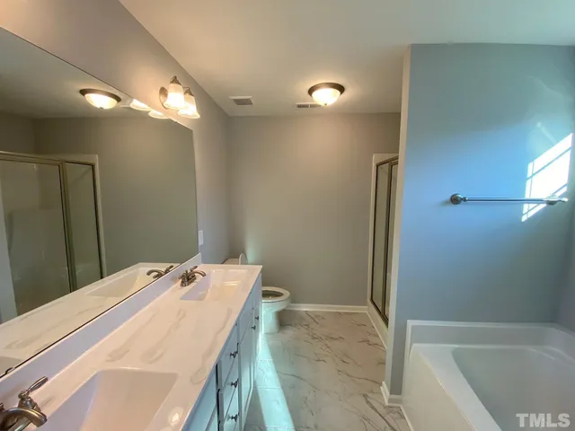 a bathroom with a tub sink and vanity