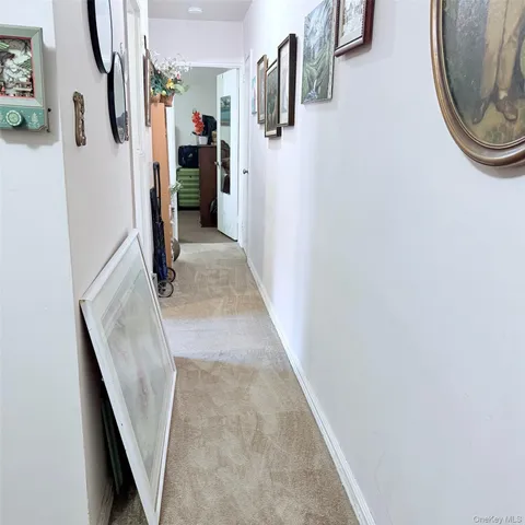 a view of a hallway with walk in closet