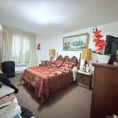 a bed room with a bed and a chair