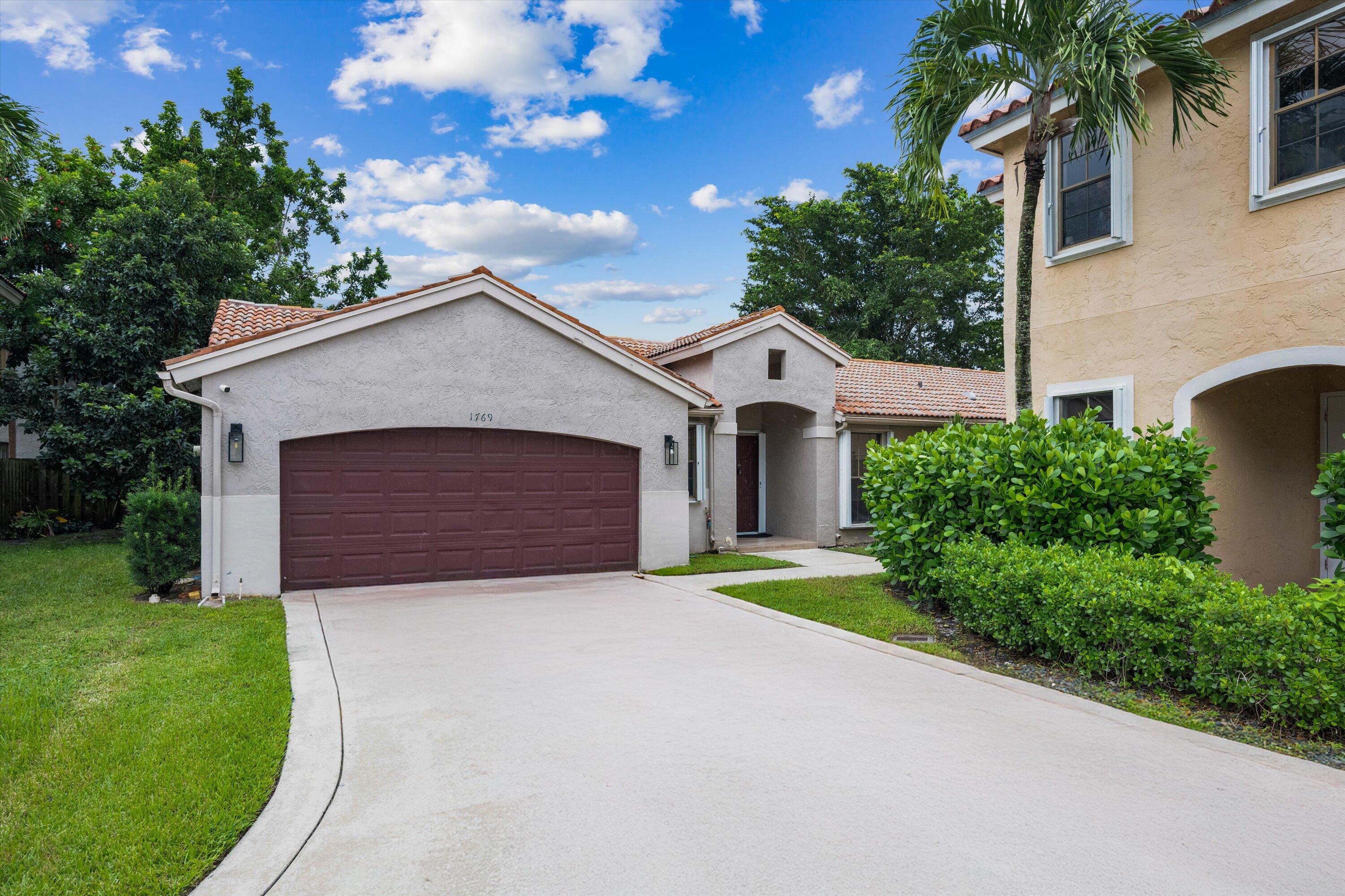 a front view of a house with a yard and garage