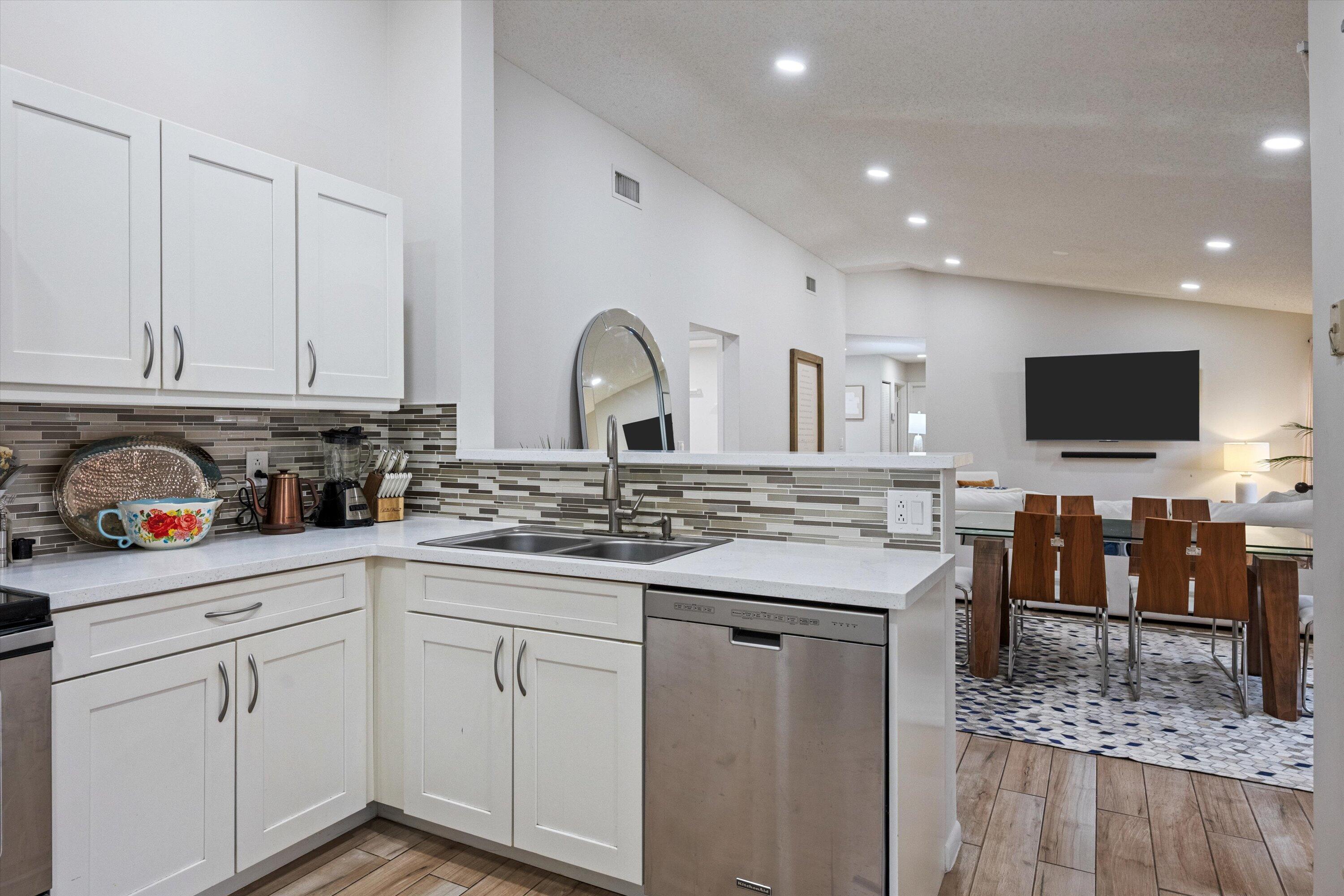 1769 Harborside Circle Wellington, FL 33414 - Photo 12 of 34 a kitchen with white cabinets and appliances