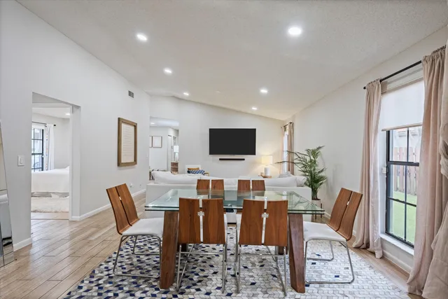 a living room with furniture a flat screen tv and a table