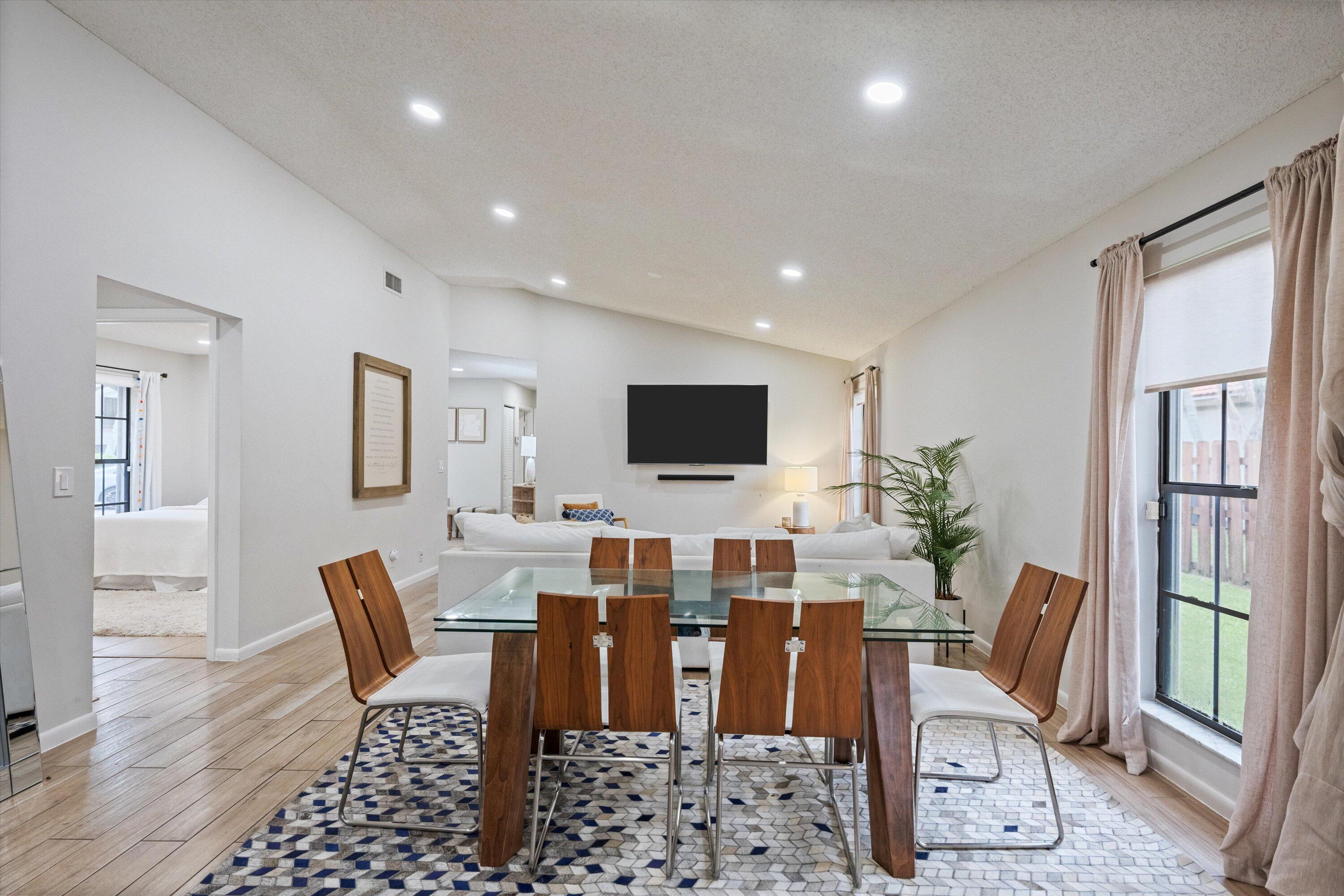 1769 Harborside Circle Wellington, FL 33414 - Photo 13 of 34 a living room with furniture a flat screen tv and a table