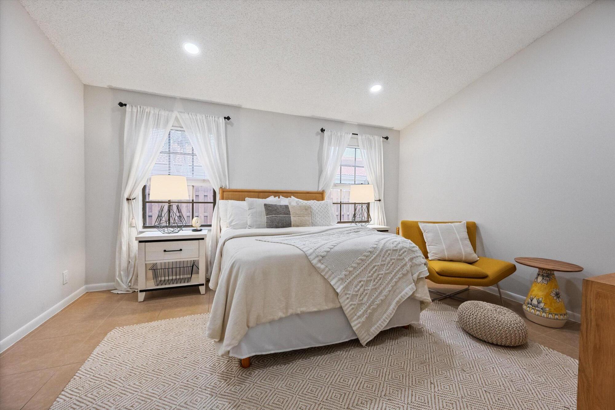 1769 Harborside Circle Wellington, FL 33414 - Photo 15 of 34 a bedroom with a bed and a refrigerator