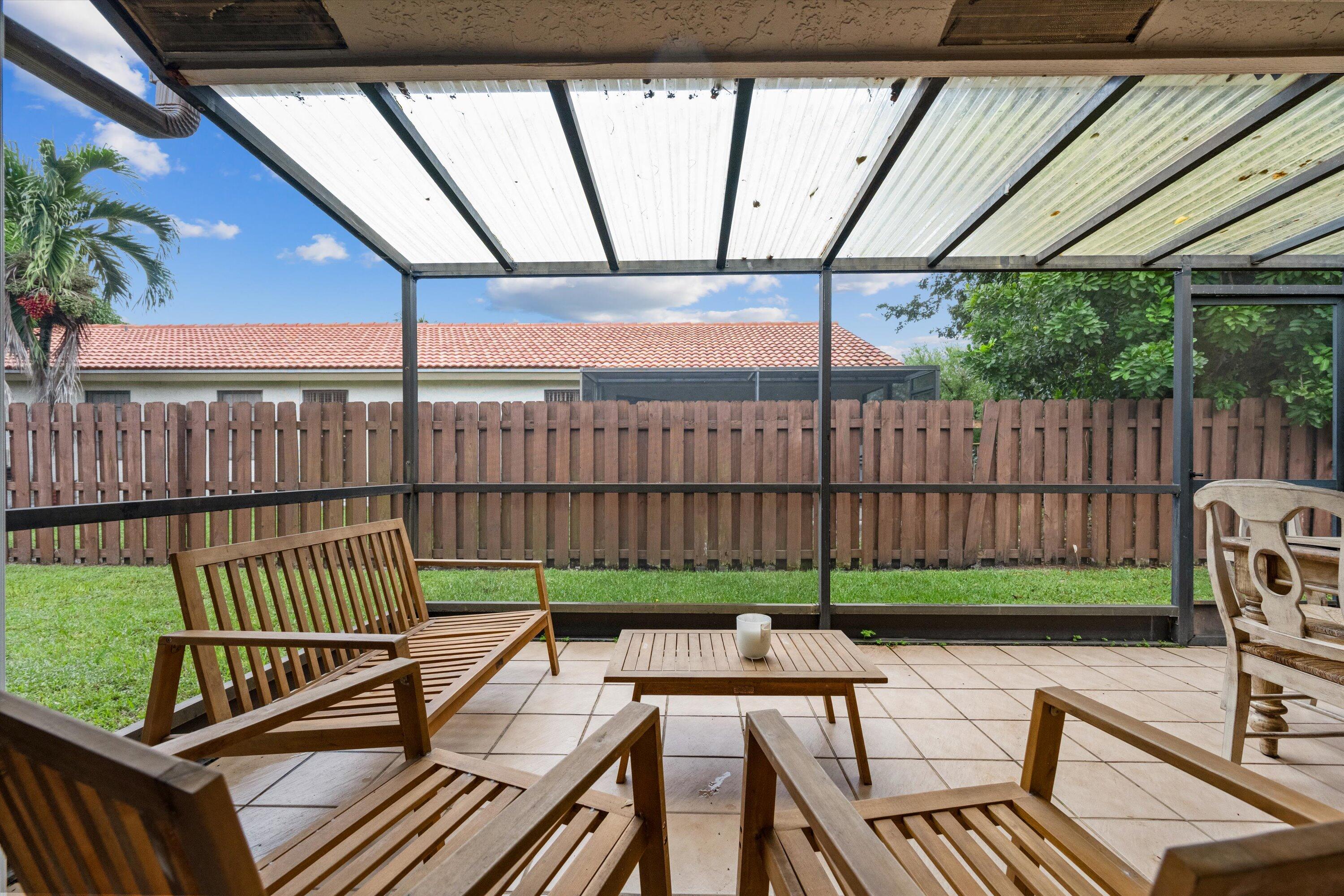 1769 Harborside Circle Wellington, FL 33414 - Photo 2 of 34 a view of a roof deck with wooden fence