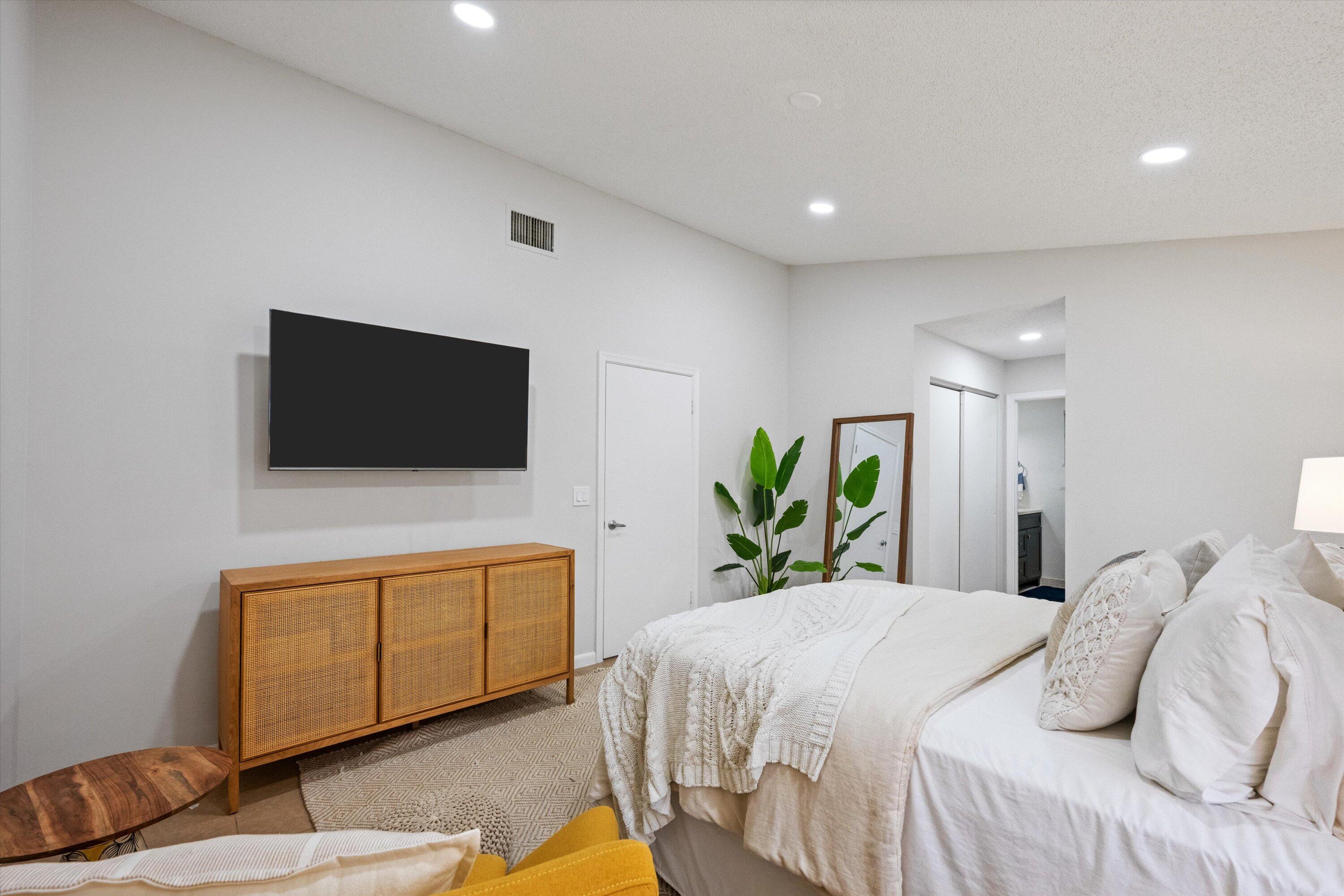 1769 Harborside Circle Wellington, FL 33414 - Photo 21 of 34 a bedroom with a bed and a flat screen tv