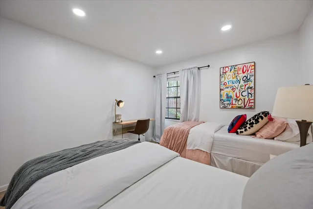 a bedroom with two beds and a couch