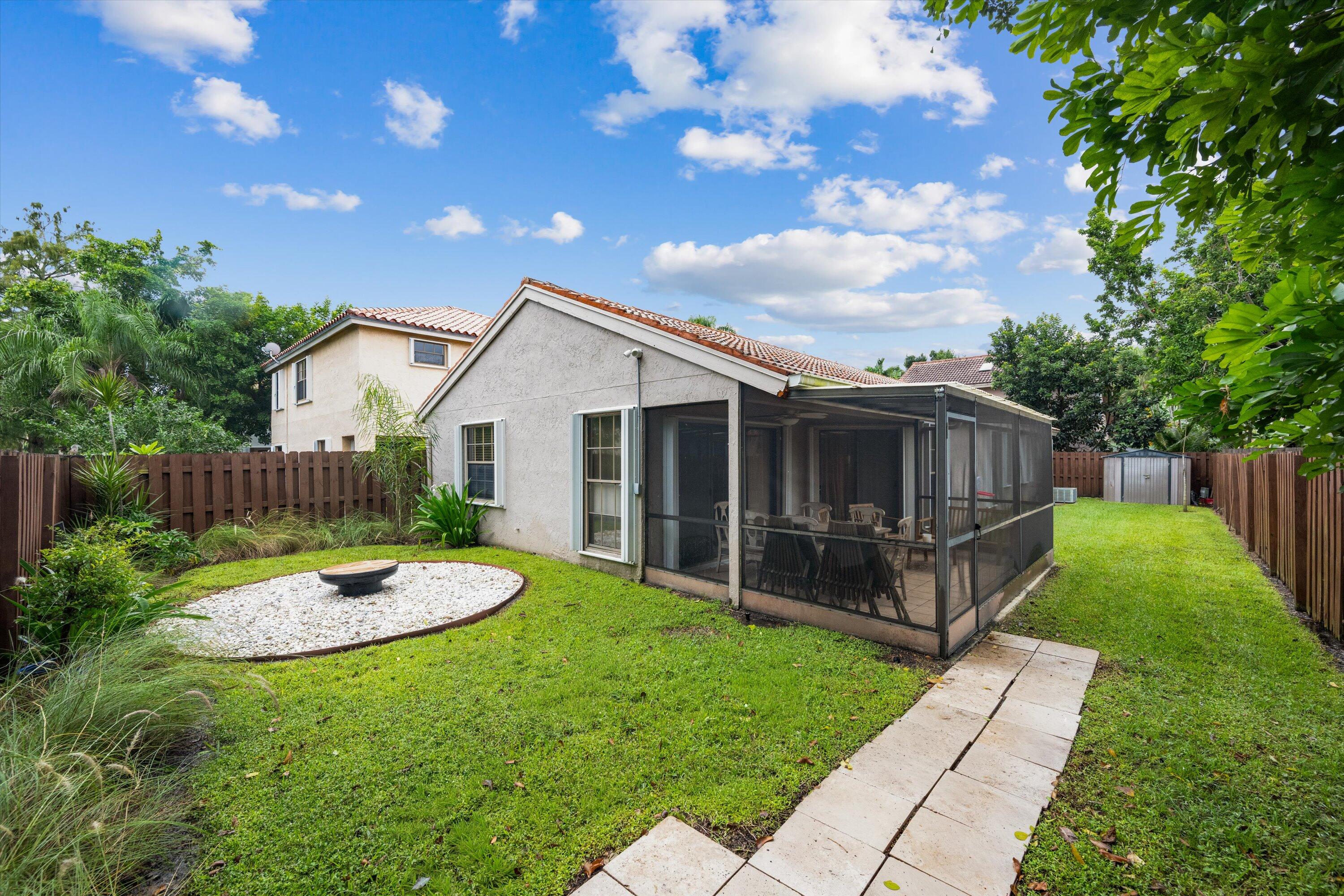 1769 Harborside Circle Wellington, FL 33414 - Photo 29 of 34 a front view of a house with garden