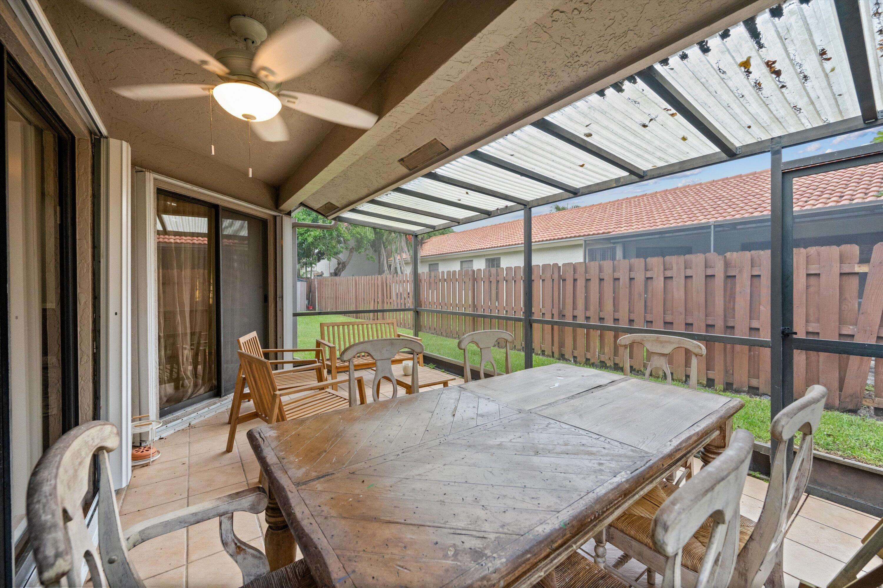 1769 Harborside Circle Wellington, FL 33414 - Photo 31 of 34 a dining room with furniture a chandelier and wooden floor