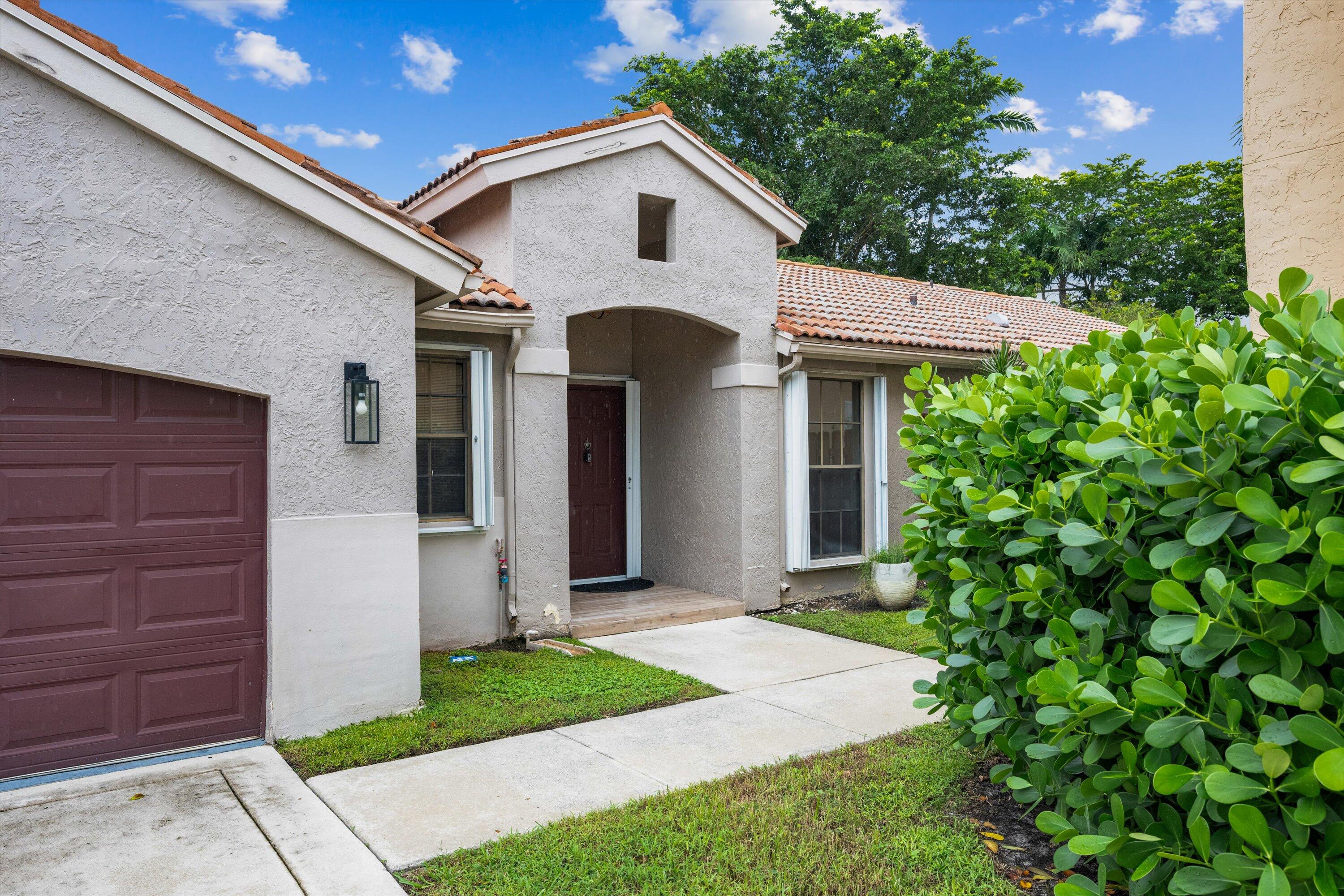 1769 Harborside Circle Wellington, FL 33414 - Photo 33 of 34 a front view of a house with a garden