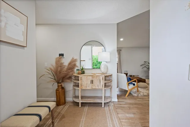 a living room with furniture a rug and white walls